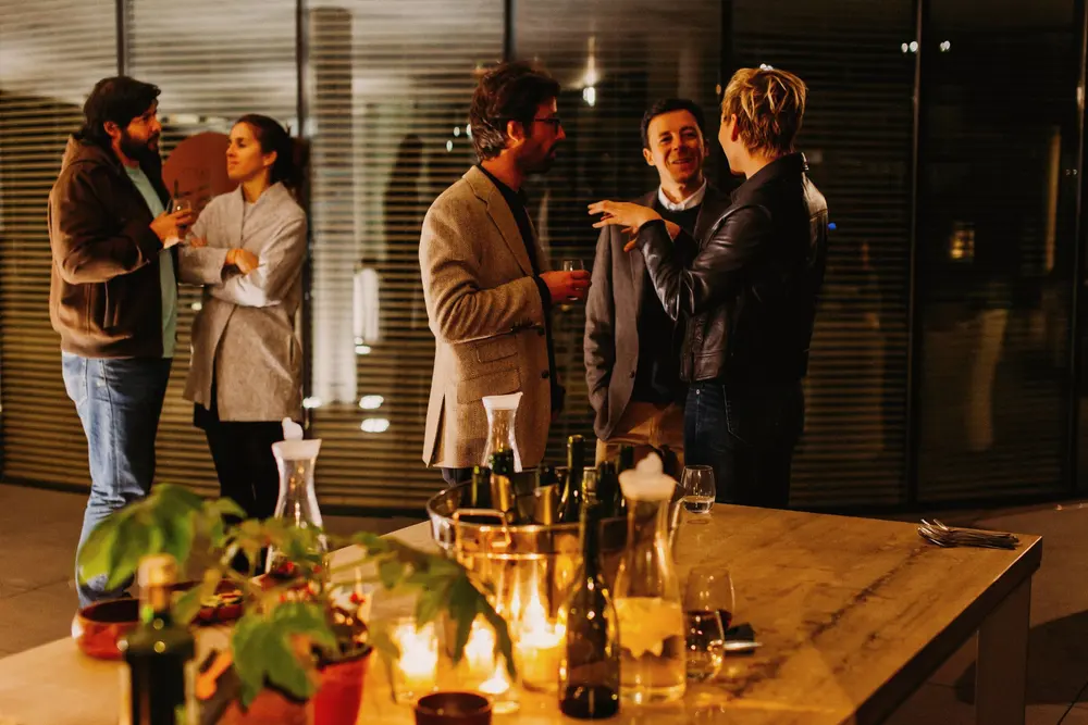 Guests talking over drinks at registration