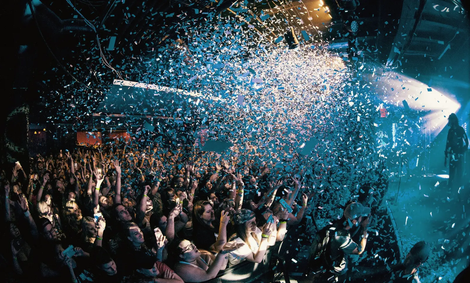 Audience celebrating as confetti fills the venue