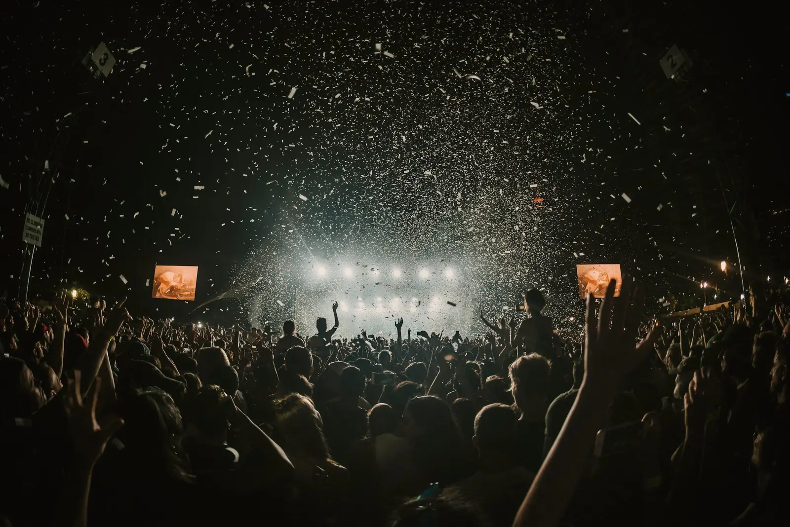Crowd in silhouette under stage lights