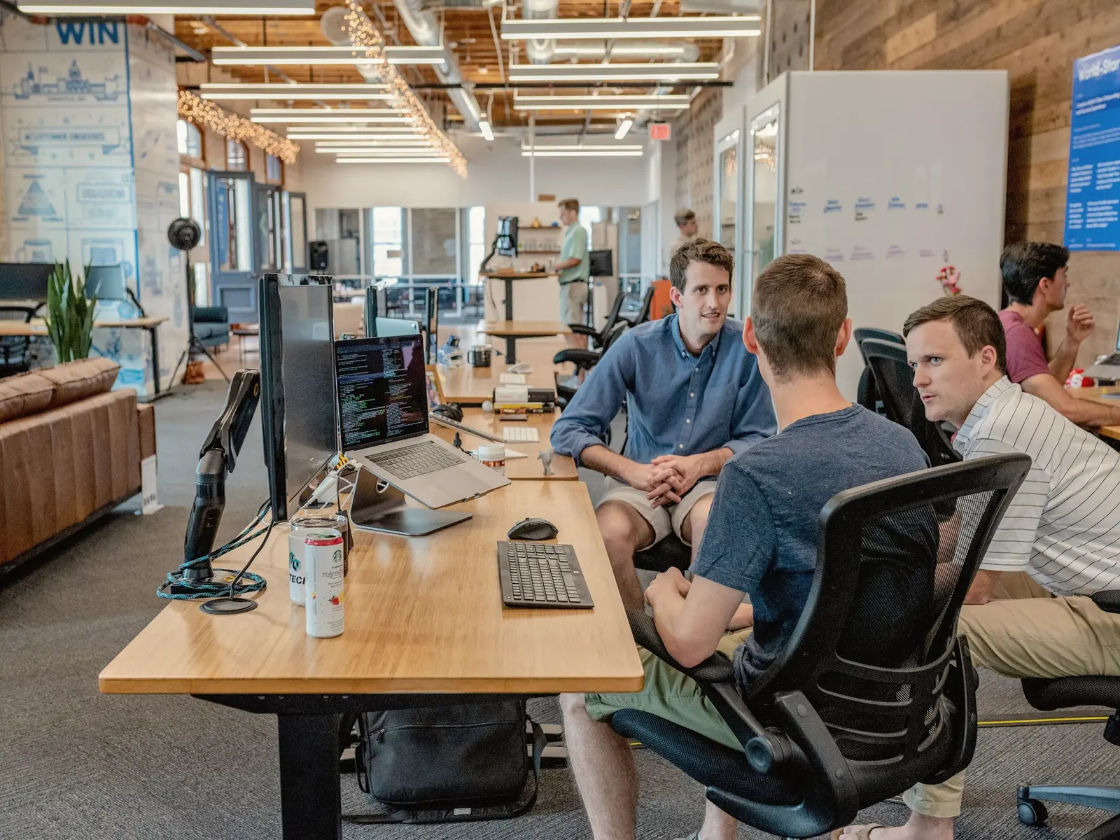 Open-plan office with people working at long desks