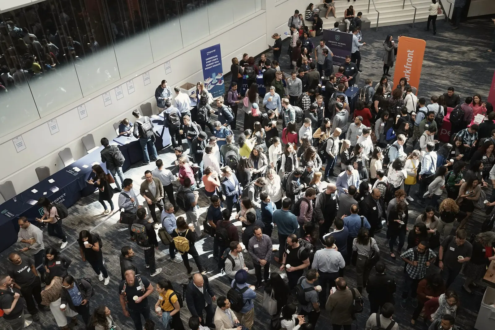 Mulțime de participanți care umplu sala principală