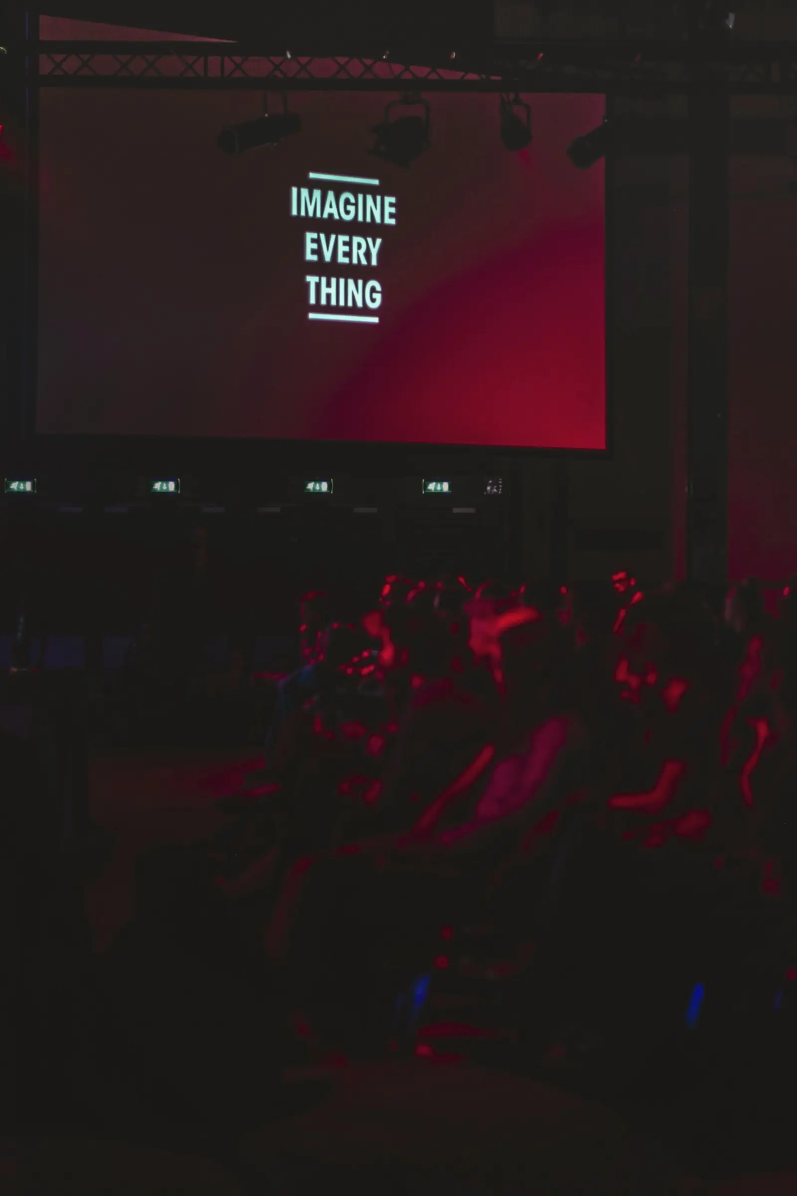 Large screen with presentation slide in a dark hall